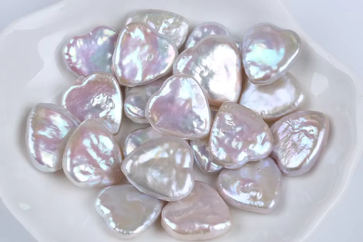 Flat white baroque pearls in a shallow dish
