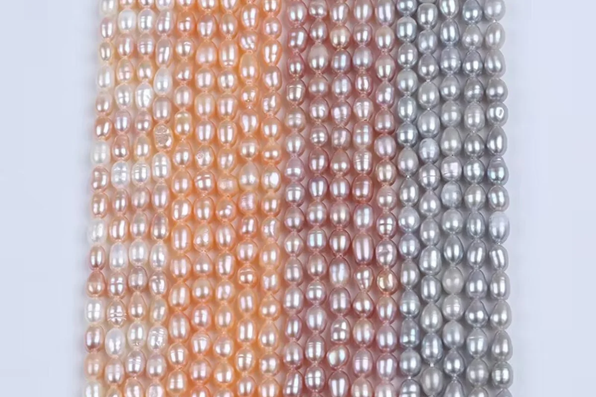 Peach pink and gray pearl strands arranged side by side