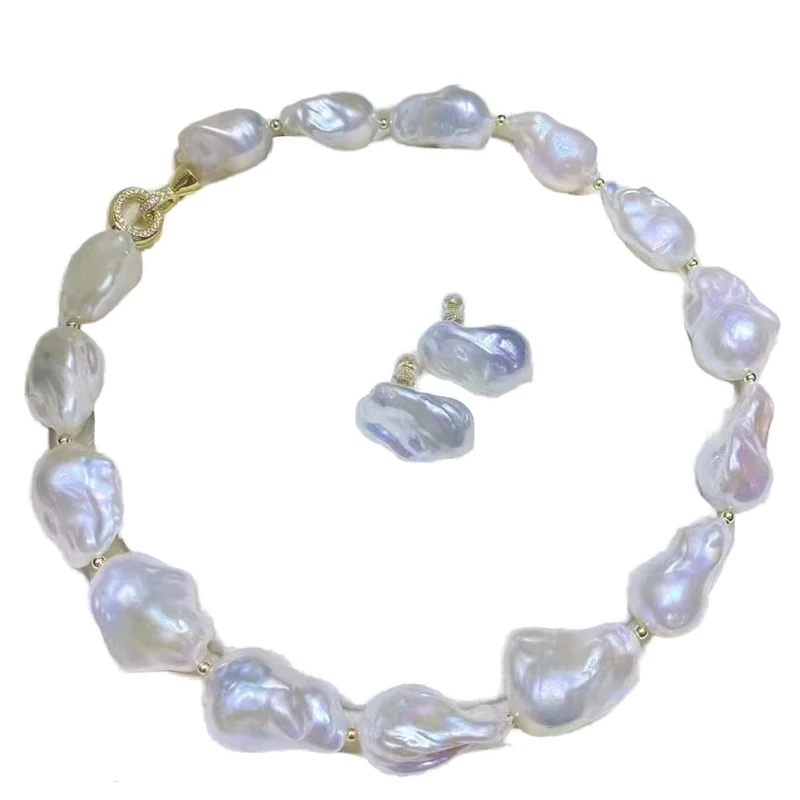 A coordinated baroque pearl necklace and earring set on white.