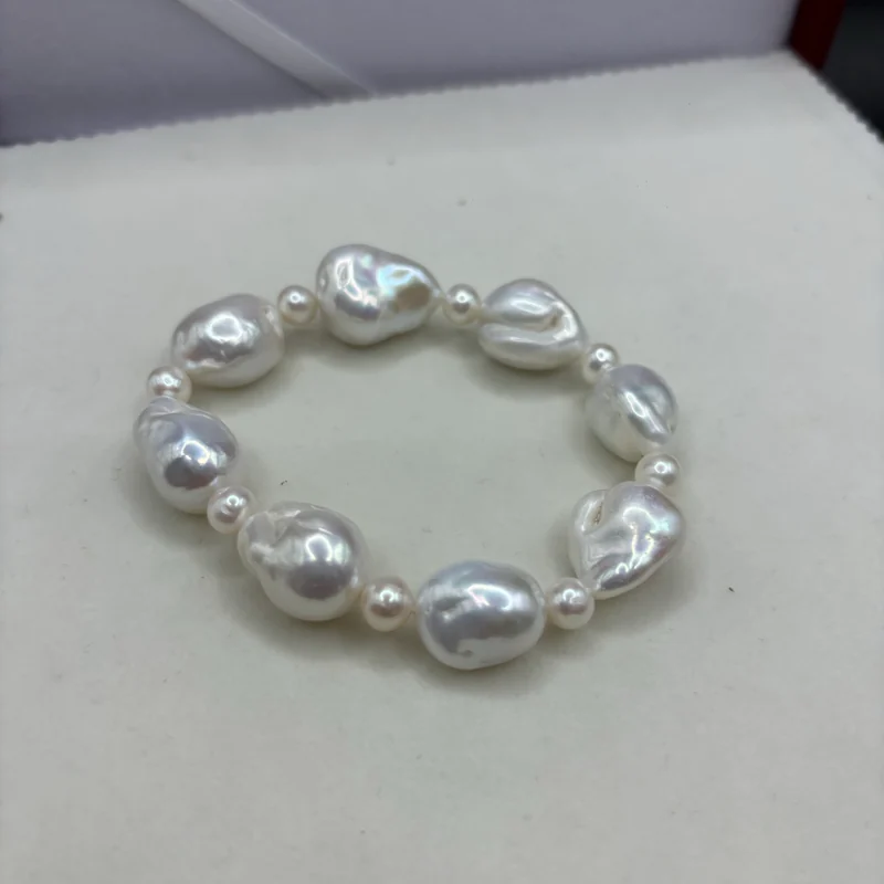 A bracelet of large white baroque pearls with small pearl spacers.