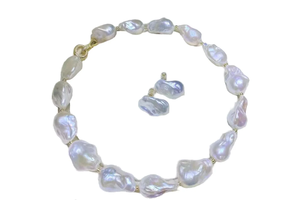 A large white baroque pearl necklace with matching pearl earrings.
