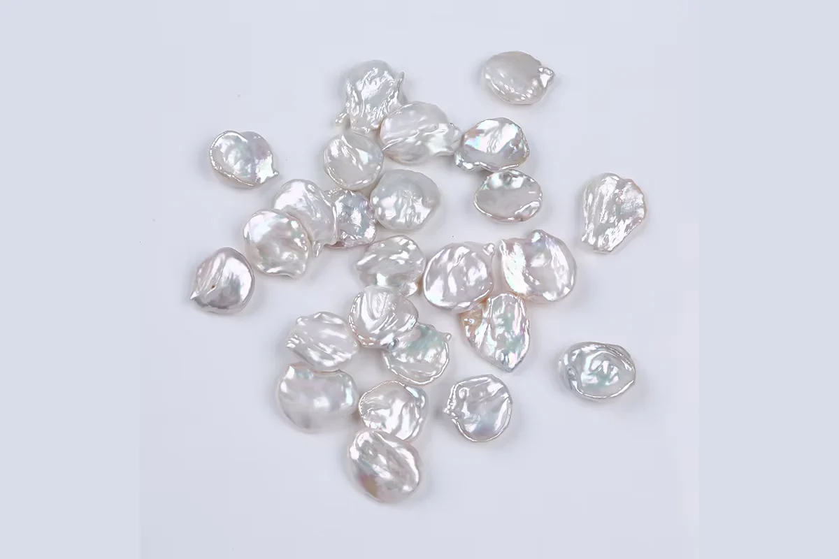 White flat pearls showing varied irregular outlines.