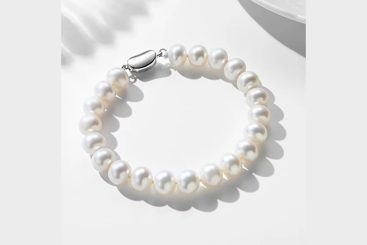 A white pearl strand bracelet with its clasp visible.