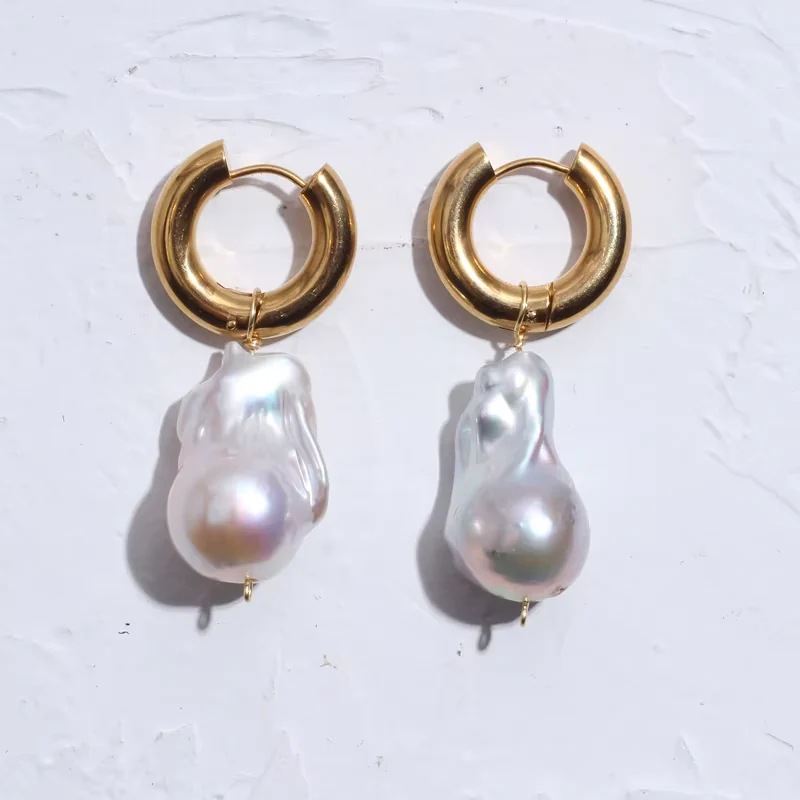 Hoop earrings with large white baroque pearl drops.