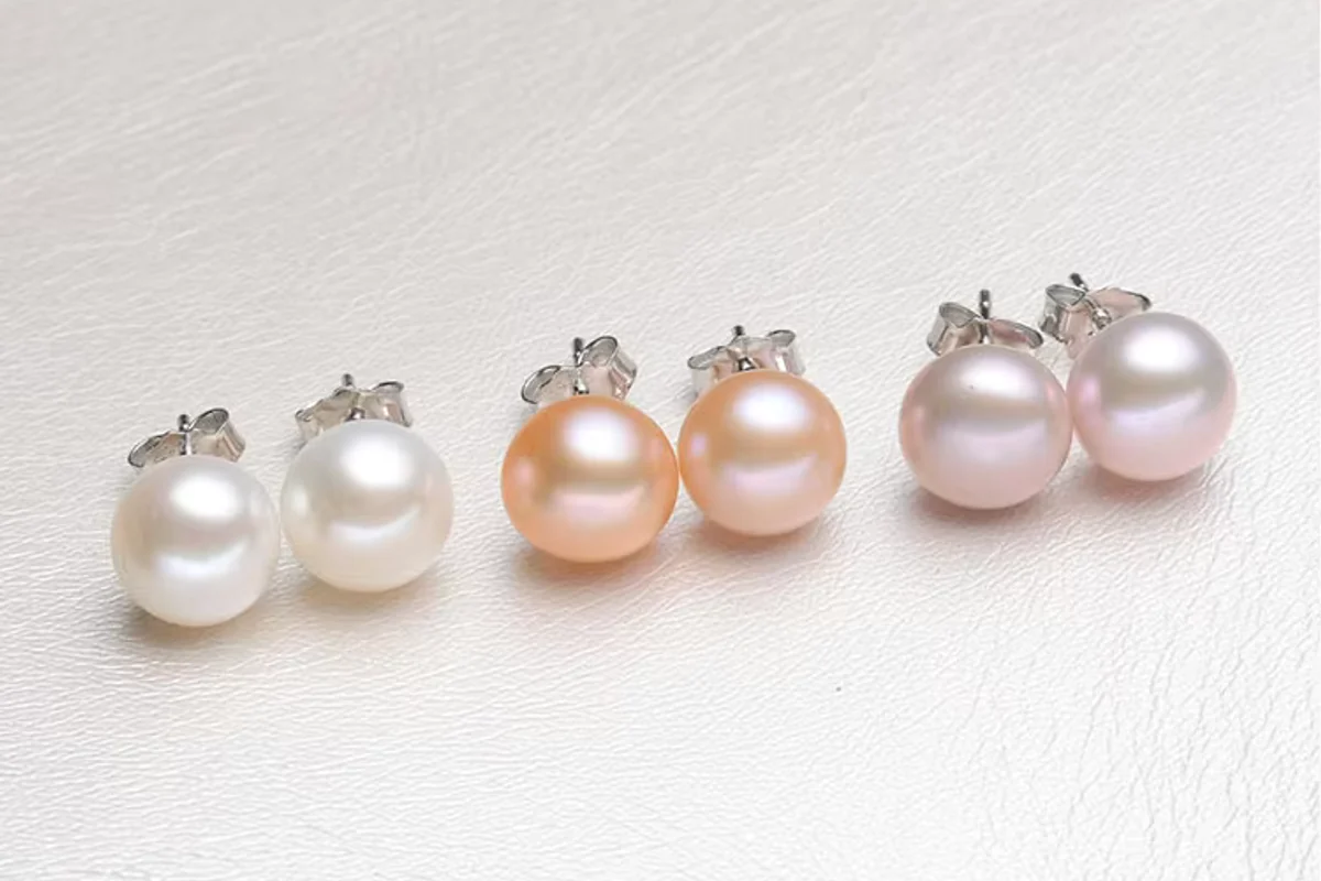 Pairs of white, peach and lavender pearl stud earrings.