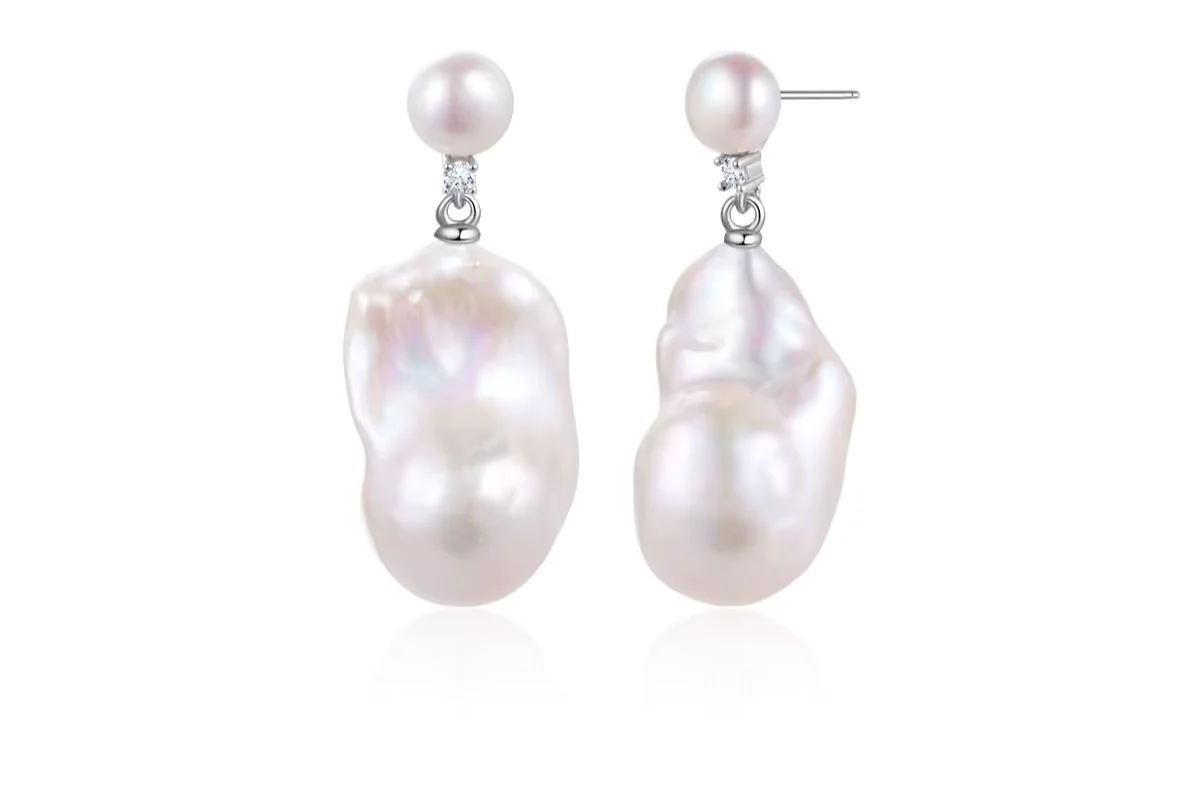 Baroque pearl earrings with suspended white pearl drops.