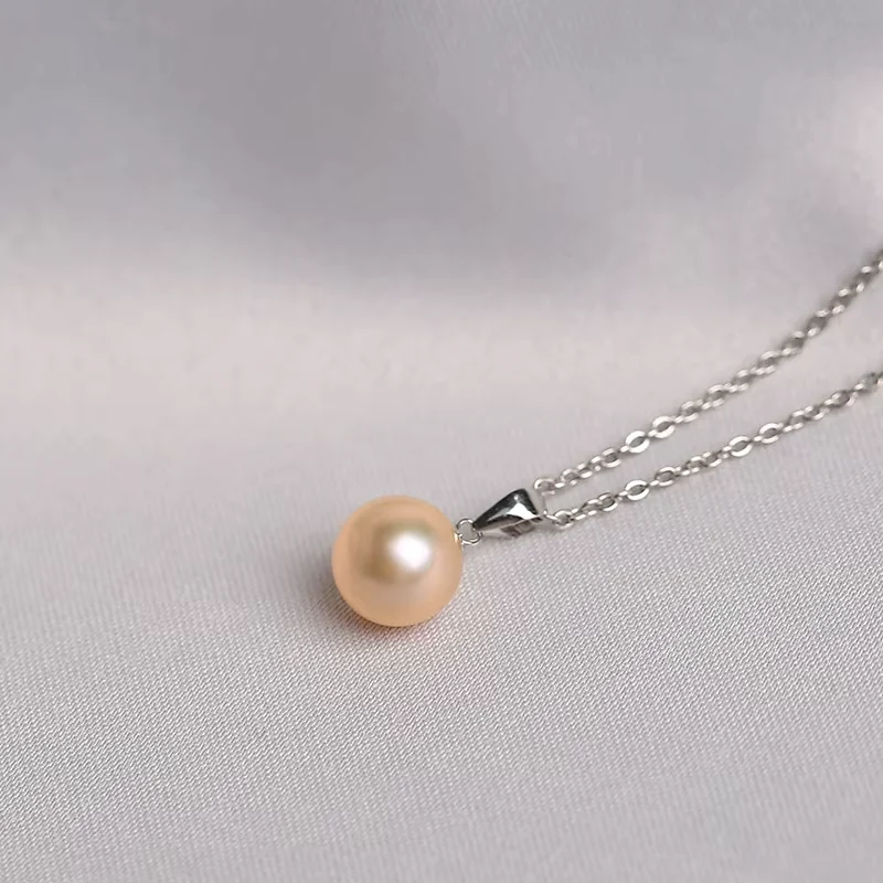 Single peach pearl pendant on a fine chain