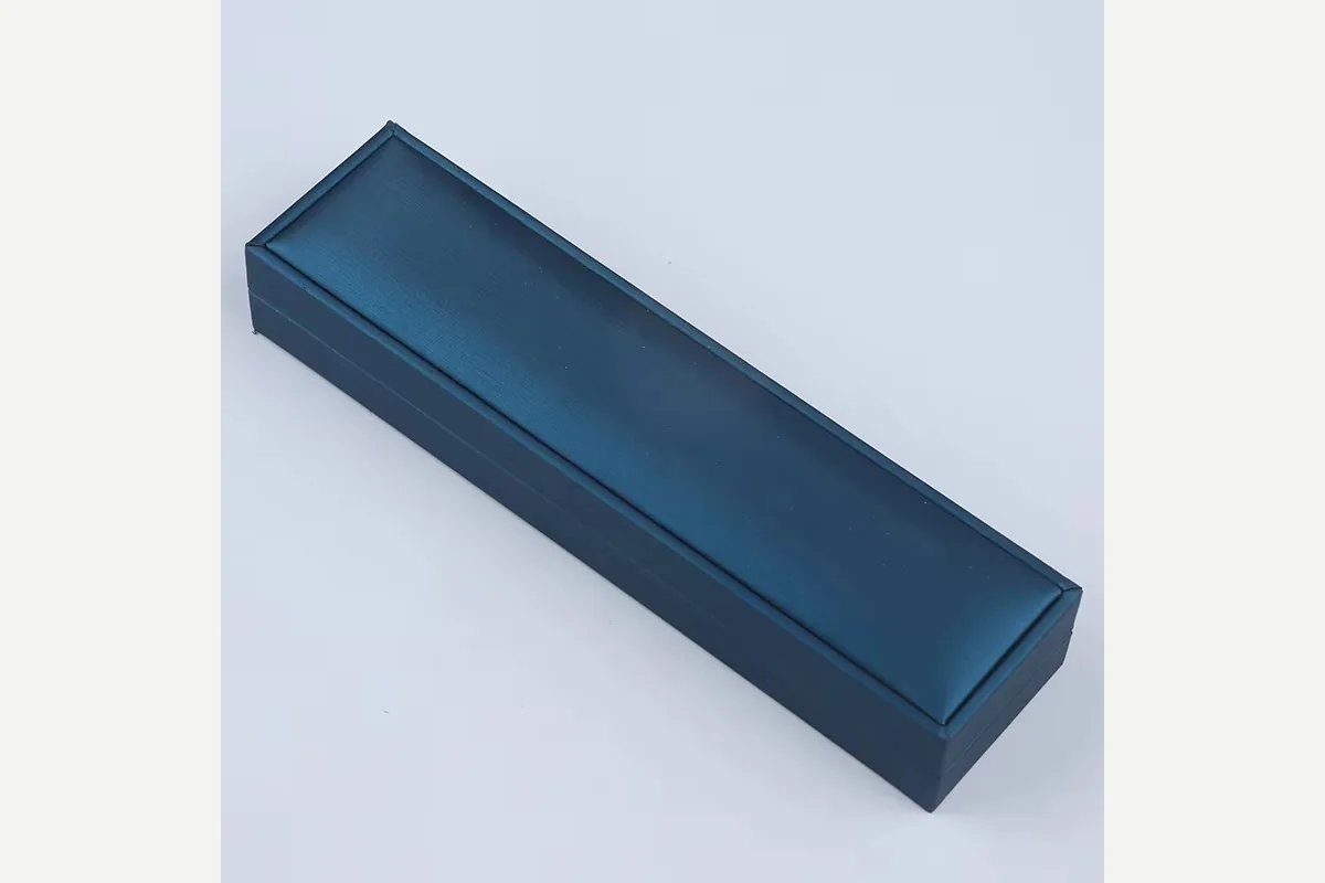 A plain closed blue rectangular jewelry box